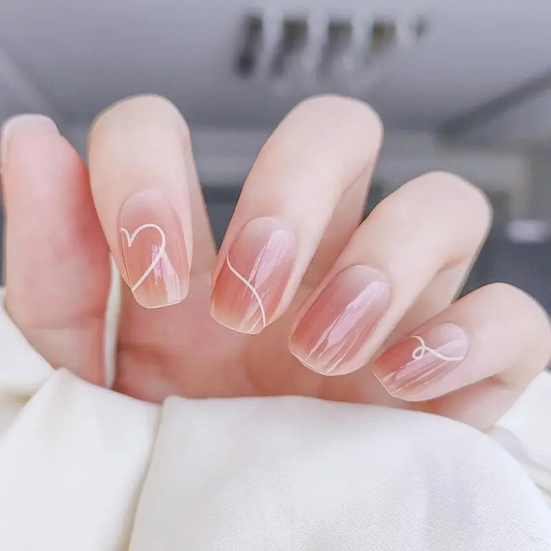 Heart Nail Designs for Valentine’s Day nude Ombre nails with white hearts